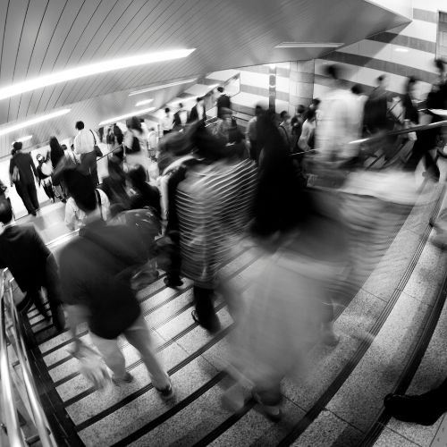 Crowded transit station with data flow representing reverse phone appending customer intelligence and demographic profiling for comprehensive contact enrichment